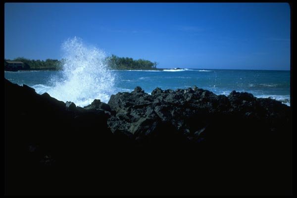 005038 Wave Breaking On Rocks In Tropical Bay A4 Photo Print