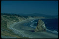 005075 Sandy Beach With Rock And Driftwood A4 Photo Print