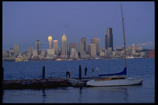 007061 Sloop At Pier With City Skyline A4 Photo Print