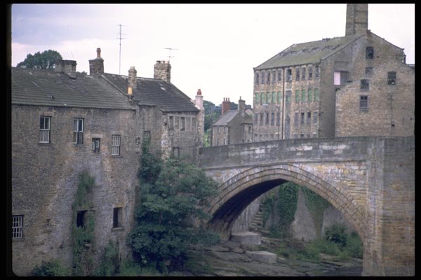 022063 Old Arched Stone Bridge And Buildings A4 Photo Print