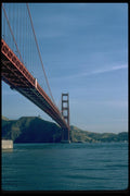 022079 Red Suspension Bridge From Water Level A4 Photo Print