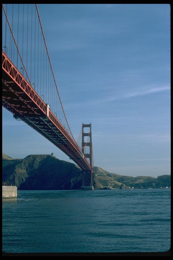 022079 Red Suspension Bridge From Water Level A4 Photo Print
