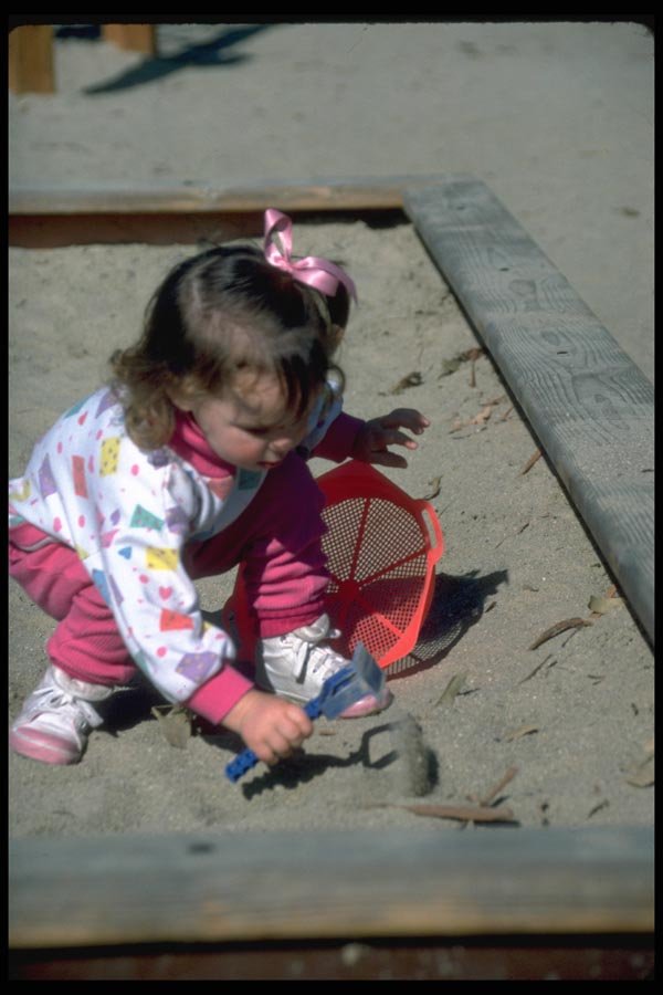 023014 Girl Playing In Sandbox A4 Photo Print