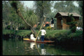 023076 Couple In Canoe Tropics A4 Photo Print
