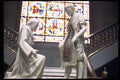 024077 Two Statues With Stained Glass Behind A4 Photo Print