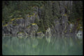 026040 Trees On Steep Rock, Green Water A4 Photo Print