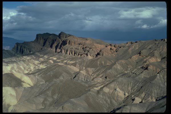 032007 Eroded Hills Under Dark Clouds A4 Photo Print