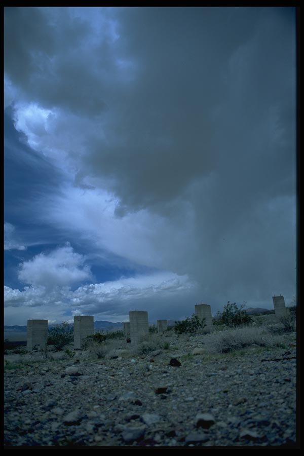032043 Cement Pilings Under Desert Rainclouds A4 Photo Print