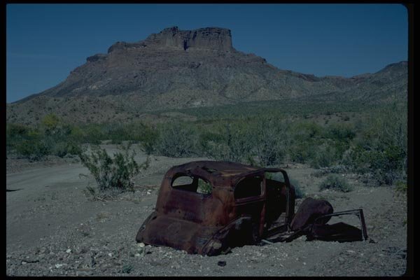 032066 Rusted Antique Car In Front Of Butte A4 Photo Print