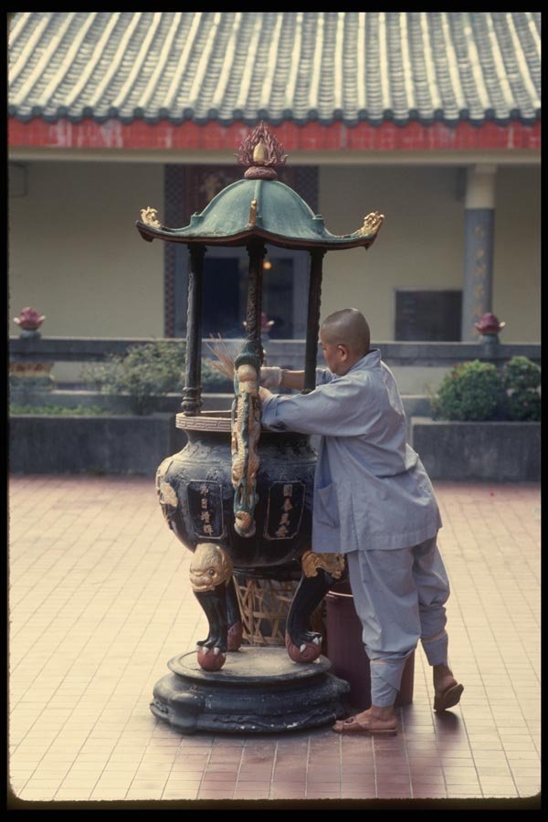 057035 Female Monk Cleaning Joss Sticks, Siong Lim Temple Complex A4 Photo Print
