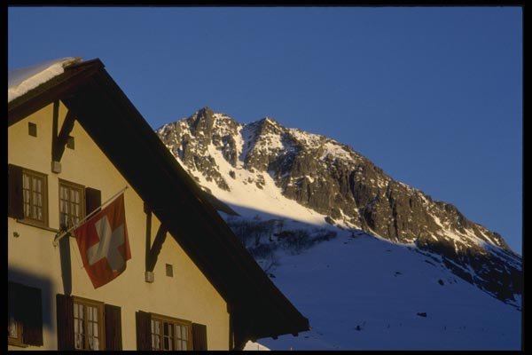 060038 Swiss Flag On Chalet In Mountains A4 Photo Print