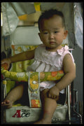 065018 Young Boy In Rolling Cart A4 Photo Print
