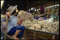 076044 Woman Selling Garlic From Boat A4 Photo Print