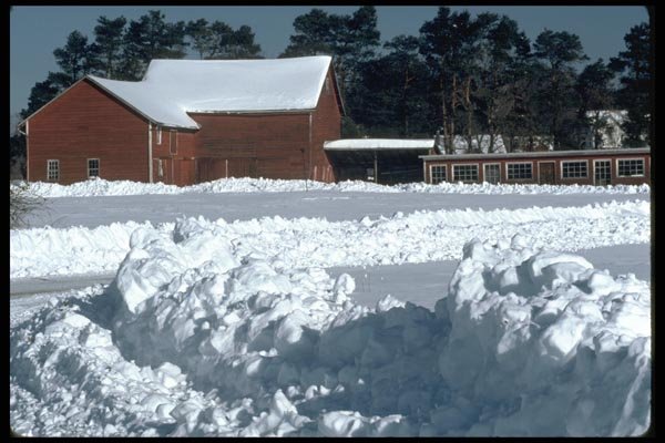 097033 Red Farm Buildings In Snow A4 Photo Print
