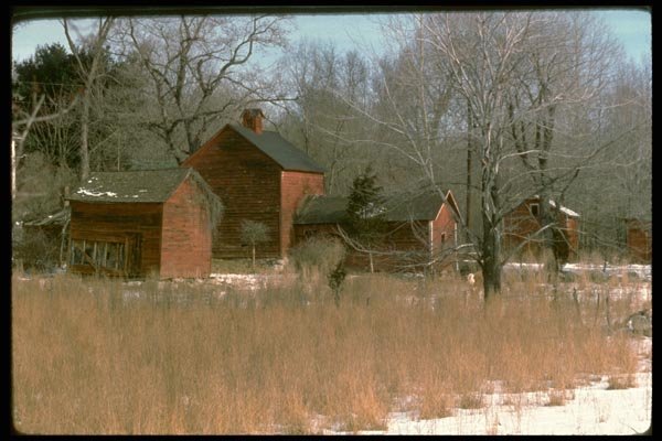 097063 Red Farm Buildings In First Snow A4 Photo Print