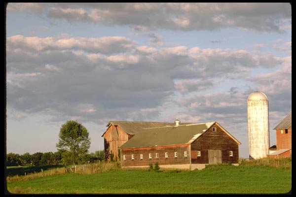 097092 Barn And Silo Under Cloudy Sky A4 Photo Print