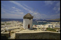 118033 Solitary Windmill Above Bustling Harbor A4 Photo Print