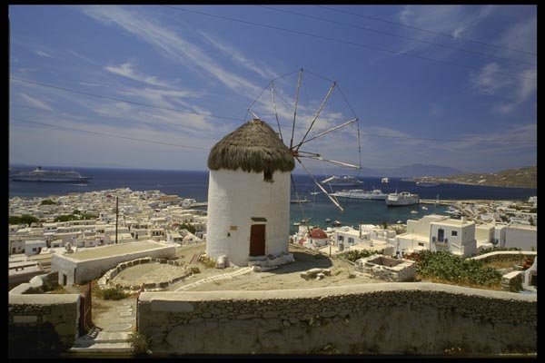 118033 Solitary Windmill Above Bustling Harbor A4 Photo Print