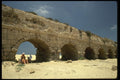 122065 Sunbathing Beneath Roman Aquaduct, Caesarea A4 Photo Print