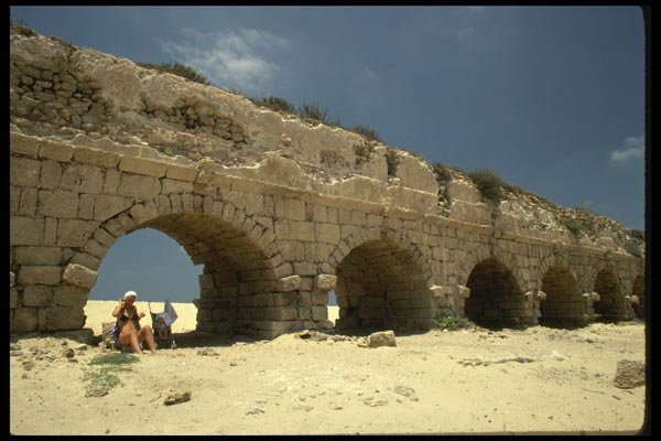 122065 Sunbathing Beneath Roman Aquaduct, Caesarea A4 Photo Print