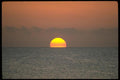 178005 Distant Sun Setting Behind Ocean A4 Photo Print