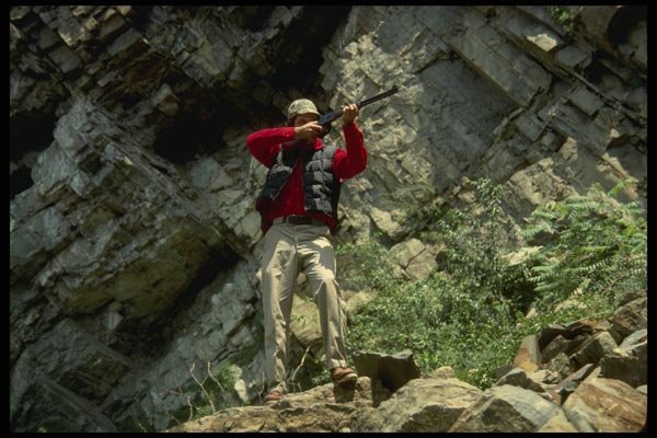 195028 Deer Hunter Shooting From Stand In Front Of Rocky Bluff A4 Photo Print