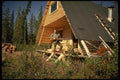 195085 Hunter Checks Gun In Front Of A Frame Hunting Cabin A4 Photo Print