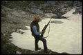 195089 Big Game Hunter Pauses Beside High Alpine Bluff A4 Photo Print