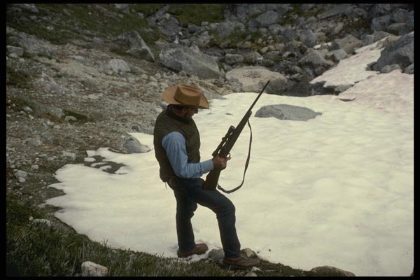 195089 Big Game Hunter Pauses Beside High Alpine Bluff A4 Photo Print