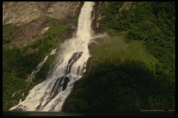 219009 Towering Waterfall Empties Into Deep Fjord A4 Photo Print
