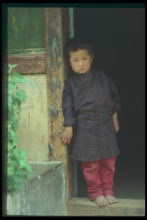 246070 Young Boy At Entrance To Home, Thimphu A4 Photo Print