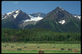 251087 Chetwynd Mountains And Round Hay Bales, BC A4 Photo Print