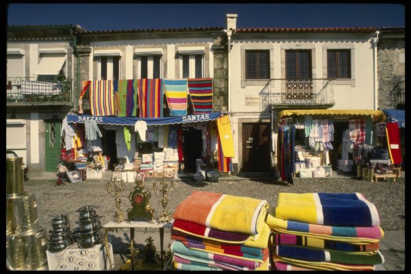 256028 Colorful Merchandise Along Cobblestone Streets A4 Photo Print