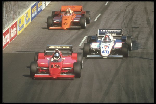 273043 A Pack Of Indy Cars Stream Into A Turn A4 Photo Print