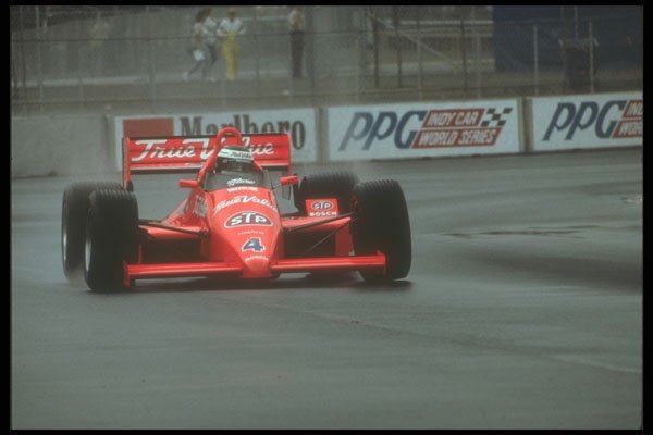 273048 An Indy Car On Rain Tires Fights For Traction In A Turn A4 Photo Print