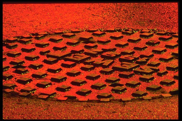 313033 Red Traffic Stop Light Reflection On Wet Manhole Cover A4 Photo Print