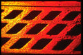 313071 Red & Yellow Light Reflecting Off Wet Catch Basin Grate A4 Photo Print