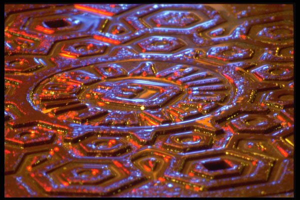 313075 Red And Amber Light Reflected Off Wet Manhole Cover A4 Photo Print