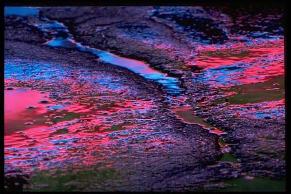 313089 Red & Blue Neon Light Reflected Off Cracked Asphalt A4 Photo Print