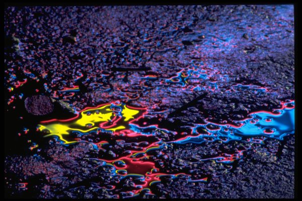 313098 Yellow, Red, Blue Neon Light Reflecting Off Cracked Asphalt A4 Photo Print
