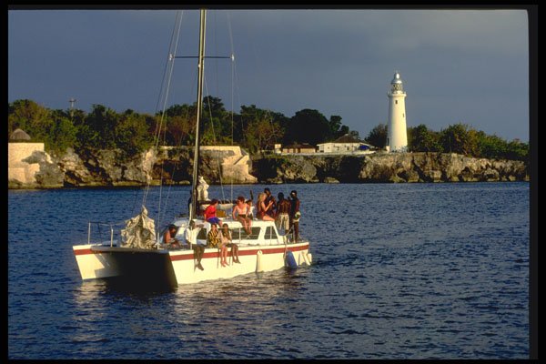 328026 Catamaran Cruises Past Negril Lighthouse A4 Photo Print