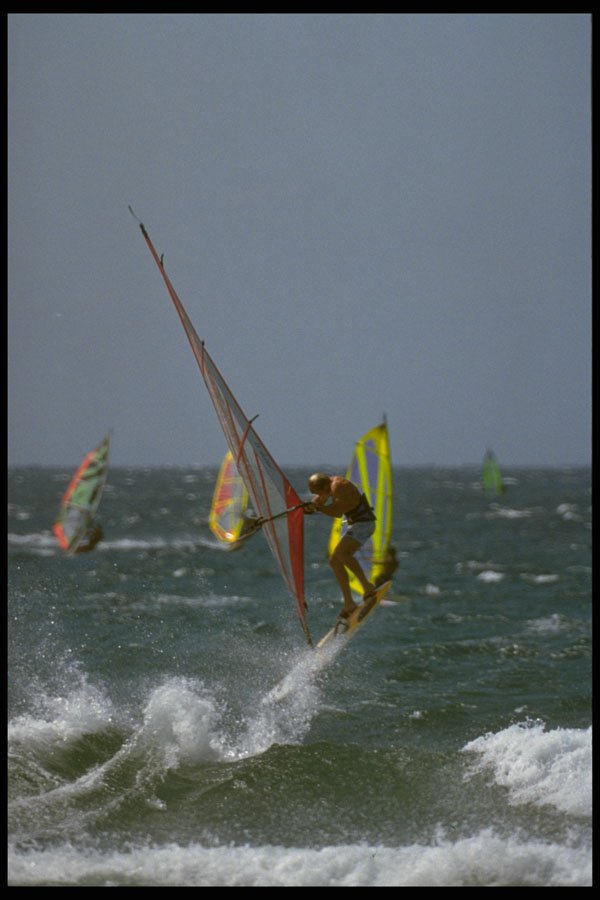 370007 Windsurfer Flying Off Wave With Other Windsurfers Behind A4 Photo Print