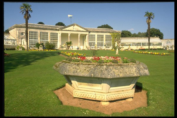 374055 Large Stone Font Filled With Flowers And Main Building A4 Photo Print