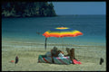 384079 Couple Reading Under Parasol On Beach, Parga, Greece A4 Photo Print