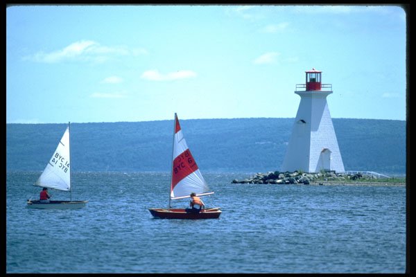 387020 Tiny Sailboats And Lighthouse, Cabot Trail, Nova Scotia A4 Photo Print