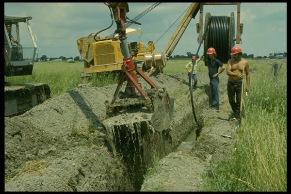 489046 Shovel Working Ahead Of Cable Layer A4 Photo Print