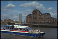 491034 A River bus Catamaran Passing The Docklands, England A4 Photo Print