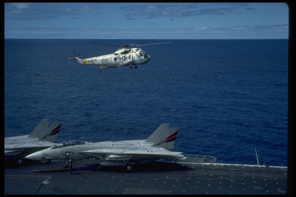 496010 SH 3 Hovers Over An F 14 On Deck A4 Photo Print