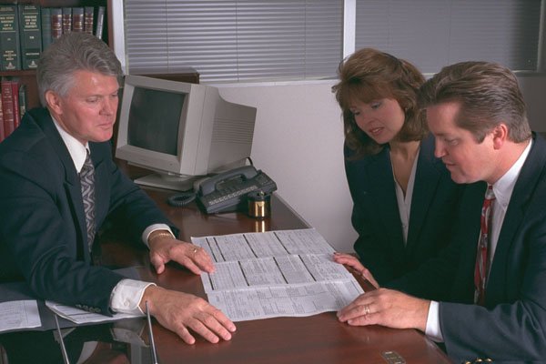 506008 A Man Showing A Married Couple Contracts At A Desk A4 Photo Print