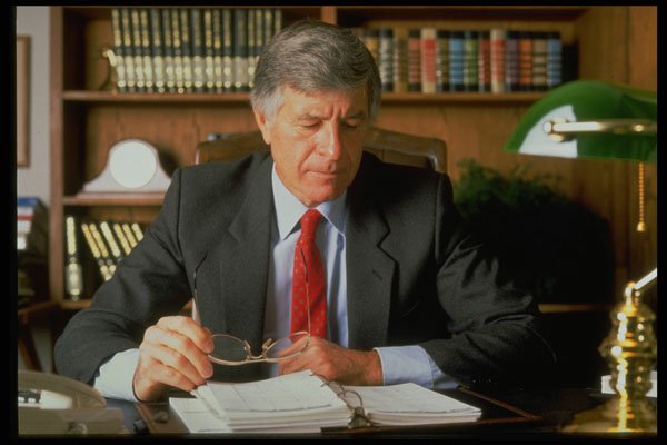 506009 A Male Executive Sitting At Desk, Reviewing Paperwork A4 Photo Print